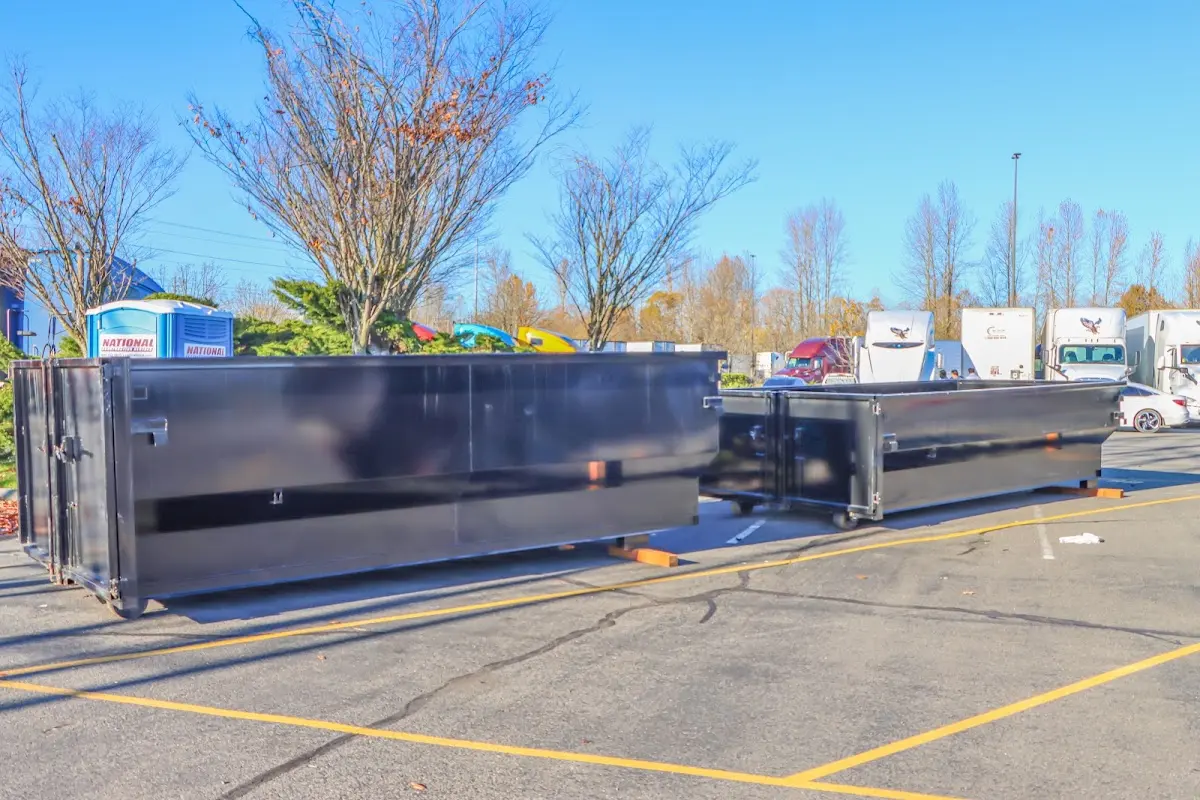 Professional dumpster rental service with roll-off container on residential driveway in Thousand Palms